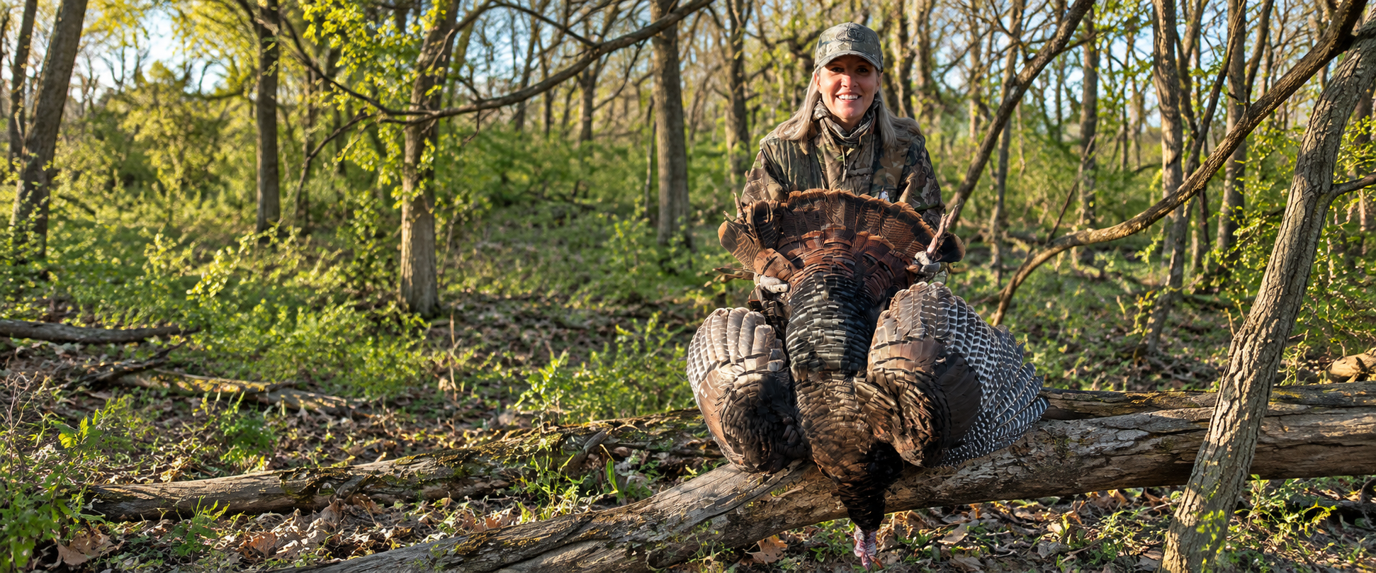 Proud Hunter with Fanned Turkey in Woodland (1)